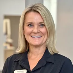 blonde staff with shoulder length hair wearing black